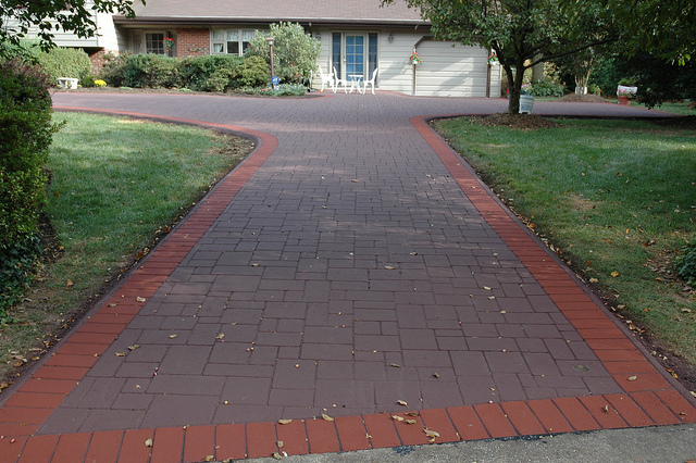 Contractor inspecting a driveway